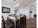 Bright dining room featuring a dark wood table with seating for six, and hardwood floors at 5003 Singletree Ln, Indian Trail, NC 28079