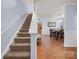 Inviting entryway featuring carpeted stairs, light-filled dining room, and gleaming hardwood floors at 5003 Singletree Ln, Indian Trail, NC 28079