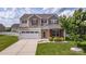 Charming two-story home featuring a well-manicured lawn and a two-car garage at 5003 Singletree Ln, Indian Trail, NC 28079