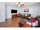 Comfortable living room featuring hardwood floors, a ceiling fan, and a large sectional sofa at 5003 Singletree Ln, Indian Trail, NC 28079