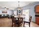 Inviting living room with hardwood floors, a round dining table and natural light at 5003 Singletree Ln, Indian Trail, NC 28079