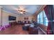 Spacious living room with hardwood floors, a ceiling fan, large windows, and comfortable seating area at 5003 Singletree Ln, Indian Trail, NC 28079