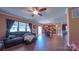 Bright living room with hardwood floors, a ceiling fan, and open access to a well-lit dining area at 5003 Singletree Ln, Indian Trail, NC 28079