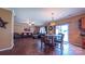Open-concept living room featuring hardwood floors, modern lighting, and a sliding glass door to outside at 5003 Singletree Ln, Indian Trail, NC 28079