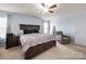 Relaxing main bedroom featuring a large bed, soft carpet, and a cozy armchair at 5003 Singletree Ln, Indian Trail, NC 28079