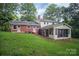 Brick and siding house exterior with a screened in porch, and a spacious, grassy backyard at 506 Richards Dr, Shelby, NC 28150