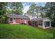 Exterior rear view of a house with spacious yard, featuring brick accents and a screened porch at 506 Richards Dr, Shelby, NC 28150