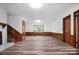 Open basement area with wood-look flooring, wainscotting, and access to upper floors at 506 Richards Dr, Shelby, NC 28150