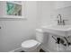 Small bathroom features a standard toilet and white sink with classic faucet at 506 Richards Dr, Shelby, NC 28150