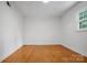Bright bedroom with hardwood floors and natural light streaming through a single window at 506 Richards Dr, Shelby, NC 28150