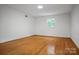 Bright bedroom with hardwood floors and natural light streaming through a single window at 506 Richards Dr, Shelby, NC 28150