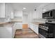 Bright kitchen features white cabinetry, granite countertops and stainless steel appliances at 506 Richards Dr, Shelby, NC 28150