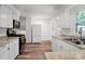 Modern kitchen features white cabinets, stainless steel appliances, and ample countertop space, ideal for culinary enthusiasts at 506 Richards Dr, Shelby, NC 28150