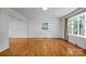 Bright living room featuring hardwood floors, large windows, and neutral paint, creating a serene and inviting atmosphere at 506 Richards Dr, Shelby, NC 28150