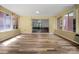 Enclosed sunroom features wood-look floors and a view of lush, mature landscaping at 506 Richards Dr, Shelby, NC 28150