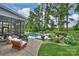 Backyard patio with outdoor seating area, pool, screened in porch, and landscaping at 562 Preservation Dr, Fort Mill, SC 29715