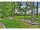 Landscaped backyard featuring meticulous landscaping, rocks, and lush green lawn at 562 Preservation Dr, Fort Mill, SC 29715