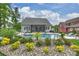 Backyard view of a freeform pool, screened-in porch, with meticulous landscaping at 562 Preservation Dr, Fort Mill, SC 29715
