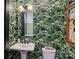 The powder room features striking green palm wallpaper, a pedestal sink, and a black framed mirror at 562 Preservation Dr, Fort Mill, SC 29715