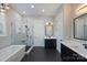 Bathroom with a glass shower, a soaking tub, dual vanities, and dark tile flooring at 562 Preservation Dr, Fort Mill, SC 29715