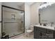 Modern bathroom with a frameless glass shower, gray vanity, and tiled flooring at 562 Preservation Dr, Fort Mill, SC 29715