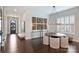 Dining room with modern lighting, unique wall art, and large windows with white shutters at 562 Preservation Dr, Fort Mill, SC 29715