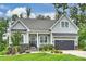 Charming single-Gathering home with manicured lawn, attached garage, and inviting front porch and lovely landscaping at 562 Preservation Dr, Fort Mill, SC 29715