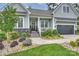 Inviting front entrance with well-maintained lawn, stone accents, and a cozy front porch with lovely landscaping at 562 Preservation Dr, Fort Mill, SC 29715