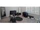 A home gym with carpeted floors, window with shutters, and workout equipment that looks hardly used at 562 Preservation Dr, Fort Mill, SC 29715