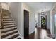 Elegant foyer boasts hardwood floors, a staircase with wooden treads, and a welcoming view of the front door at 562 Preservation Dr, Fort Mill, SC 29715