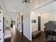Inviting foyer featuring gleaming hardwood floors, modern lighting, and a glimpse into the open-concept living space at 562 Preservation Dr, Fort Mill, SC 29715
