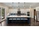 Well-equipped kitchen features a large island with seating, pendant lights, and a stainless steel appliance package at 562 Preservation Dr, Fort Mill, SC 29715