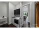 A view through a doorway to a kitchen from a laundry room with Maytag appliances and dark cabinets at 562 Preservation Dr, Fort Mill, SC 29715
