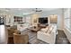 Open living room with comfortable seating, a coffee table, and unique wall decorations at 562 Preservation Dr, Fort Mill, SC 29715