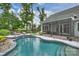 Backyard view of a freeform pool and screened-in porch, with patio area at 562 Preservation Dr, Fort Mill, SC 29715