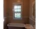 Classic bathroom with vintage tub, wainscoting, and great natural light at 607 Lee Ave, Wadesboro, NC 28170