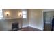 Cozy living room features a fireplace, fresh paint and trim, plus beautiful hardwood floors at 607 Lee Ave, Wadesboro, NC 28170
