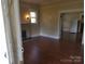 Cozy living room features a fireplace, fresh paint and trim, plus beautiful hardwood floors at 607 Lee Ave, Wadesboro, NC 28170