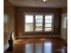 Comfortable living room area featuring hardwood floors, large windows, and neutral paint colors at 607 Lee Ave, Wadesboro, NC 28170