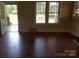 Bright living room featuring hardwood floors, large windows, and an open doorway at 607 Lee Ave, Wadesboro, NC 28170