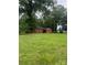 This backyard features a charming brick home surrounded by mature trees, offering a serene and private setting at 610 E Maryland Ave, Bessemer City, NC 28016