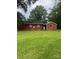 A cozy brick home nestled in a lush, green backyard, perfect for relaxation and outdoor enjoyment at 610 E Maryland Ave, Bessemer City, NC 28016