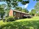 Spacious brick home featuring an elevated deck and a lush, green backyard with mature trees at 675 Godbey Rd, Salisbury, NC 28147