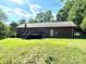 Spacious backyard with a wooden deck, mature trees, and lush green grass at 675 Godbey Rd, Salisbury, NC 28147