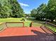 View from elevated deck onto expansive, well-manicured lawn and fenced swimming pool area at 675 Godbey Rd, Salisbury, NC 28147