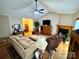 Bright living room showcasing hardwood floors, a fireplace, and an open floor plan leading to the dining area at 675 Godbey Rd, Salisbury, NC 28147
