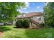 Brick house with wooden deck and stairs leading to backyard featuring plush green lawn at 6795 Montgomery Rd, Lake Wylie, SC 29710