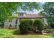 Exterior view of the back of the home showing brickwork and deck with surrounding mature landscaping at 6795 Montgomery Rd, Lake Wylie, SC 29710