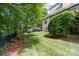 Backyard featuring plush green lawn and border of pine needles near a black, iron fence at 6795 Montgomery Rd, Lake Wylie, SC 29710