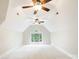 Bright bonus room featuring neutral walls, vaulted ceiling, large window, and dual ceiling fans at 6795 Montgomery Rd, Lake Wylie, SC 29710